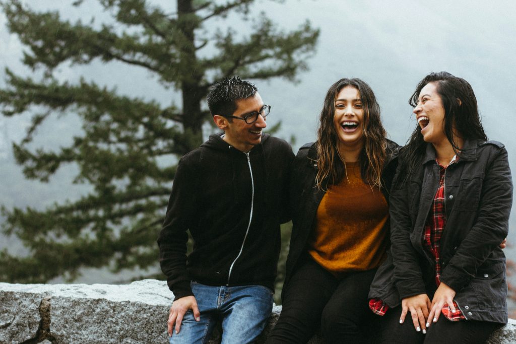 The young generation sharing a joyful moment outdoors, symbolizing friendship, resilience, and belonging in a new environment.