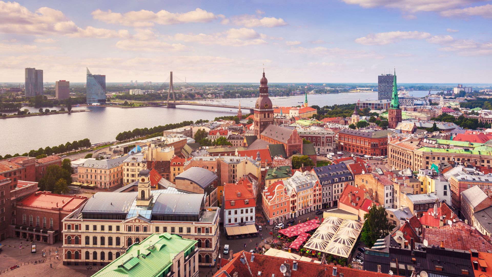 Riga city skyline with Latvia flag – Latvia residency by investment program